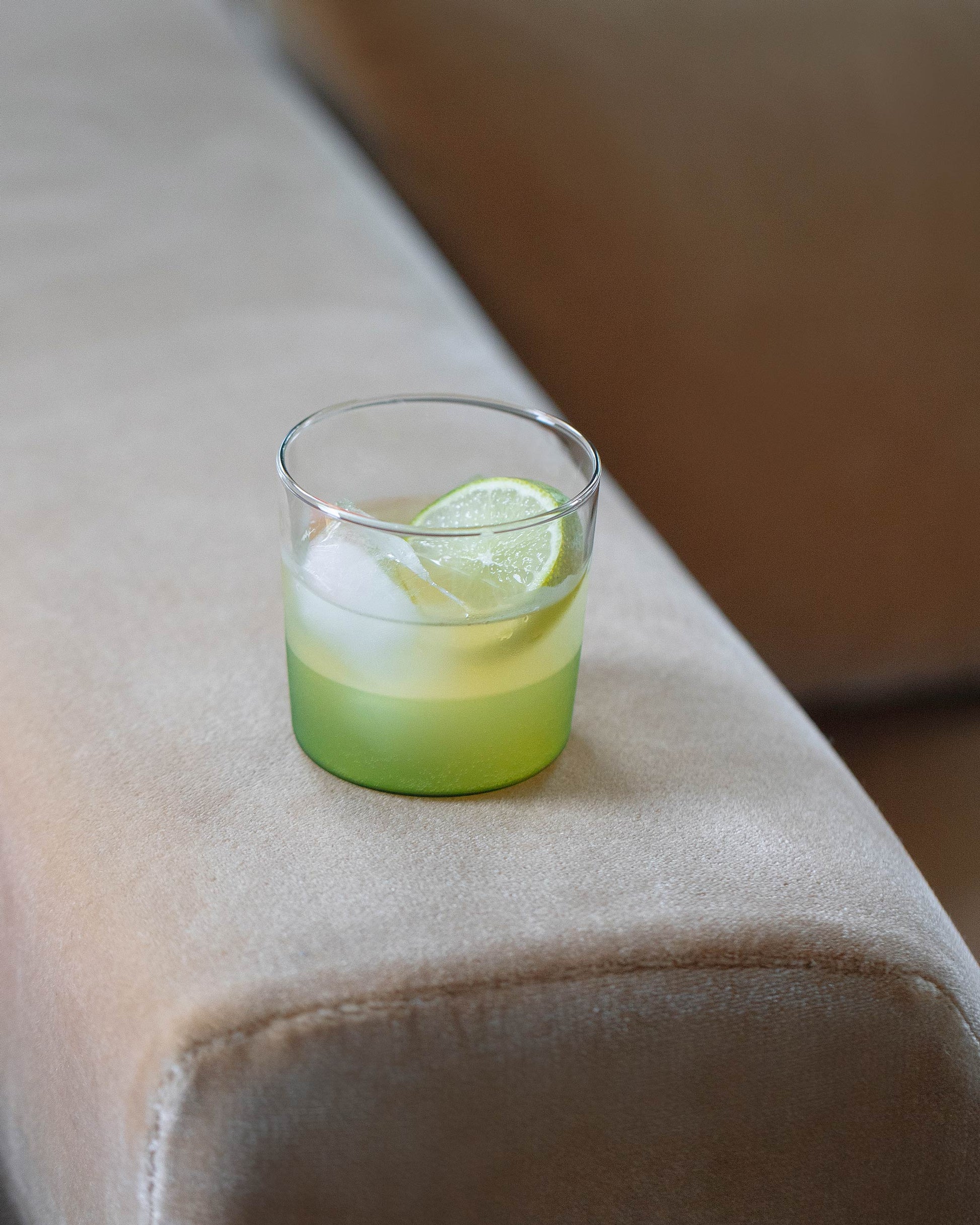 Styled image featuring the Ichendorf Milano Green/Clear Light Colore Water Glass.