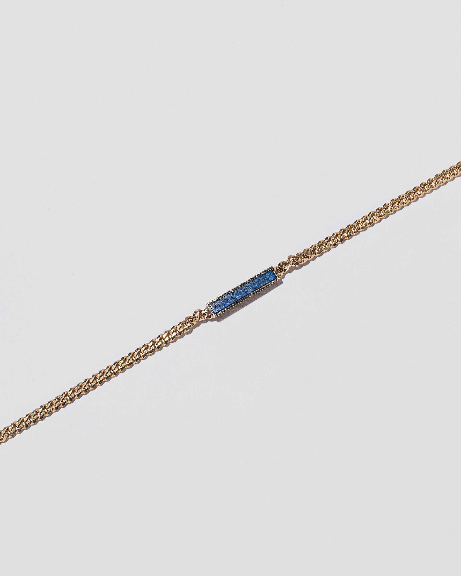 Closeup details of the Lapis 2.4mm Identity Chain Necklace on light color background.