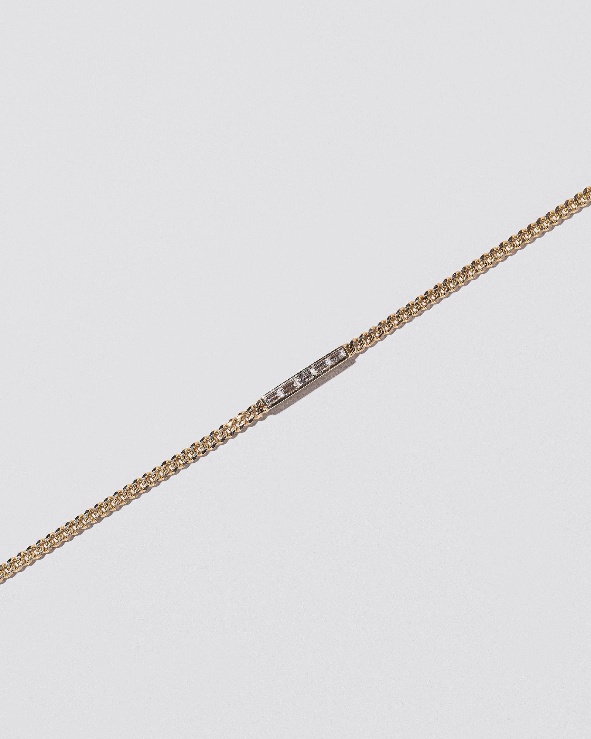 Closeup details of the White Diamond 2.4mm Identity Chain Bracelet on light colored background.