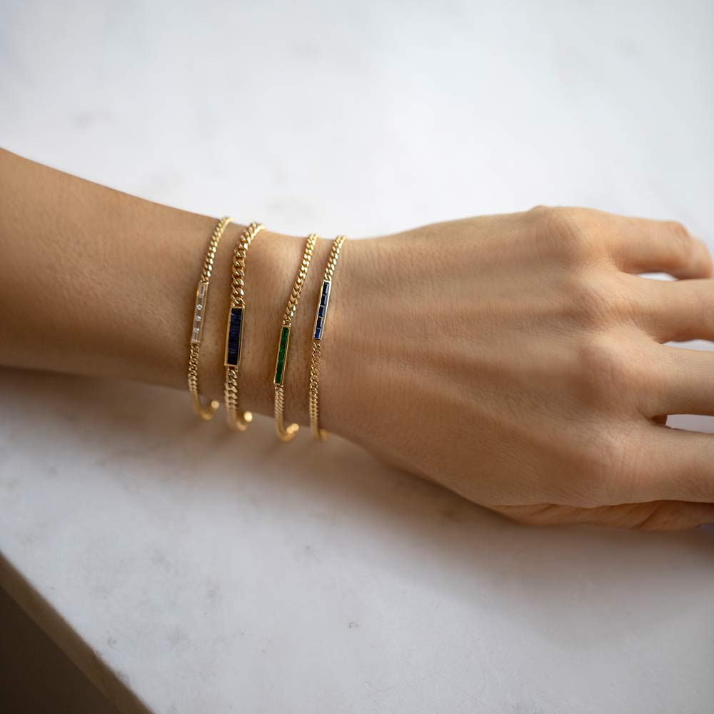 product_details::Group of Blue Sapphire, Emerald and White Diamond 2.4mm Identity Chain Bracelets and a Blue Sapphire 3.4mm Identity Chain Bracelet on model.