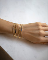 Group of Blue Sapphire, Emerald and White Diamond 2.4mm Identity Chain Bracelets and a Blue Sapphire 3.4mm Identity Chain Bracelet on model.