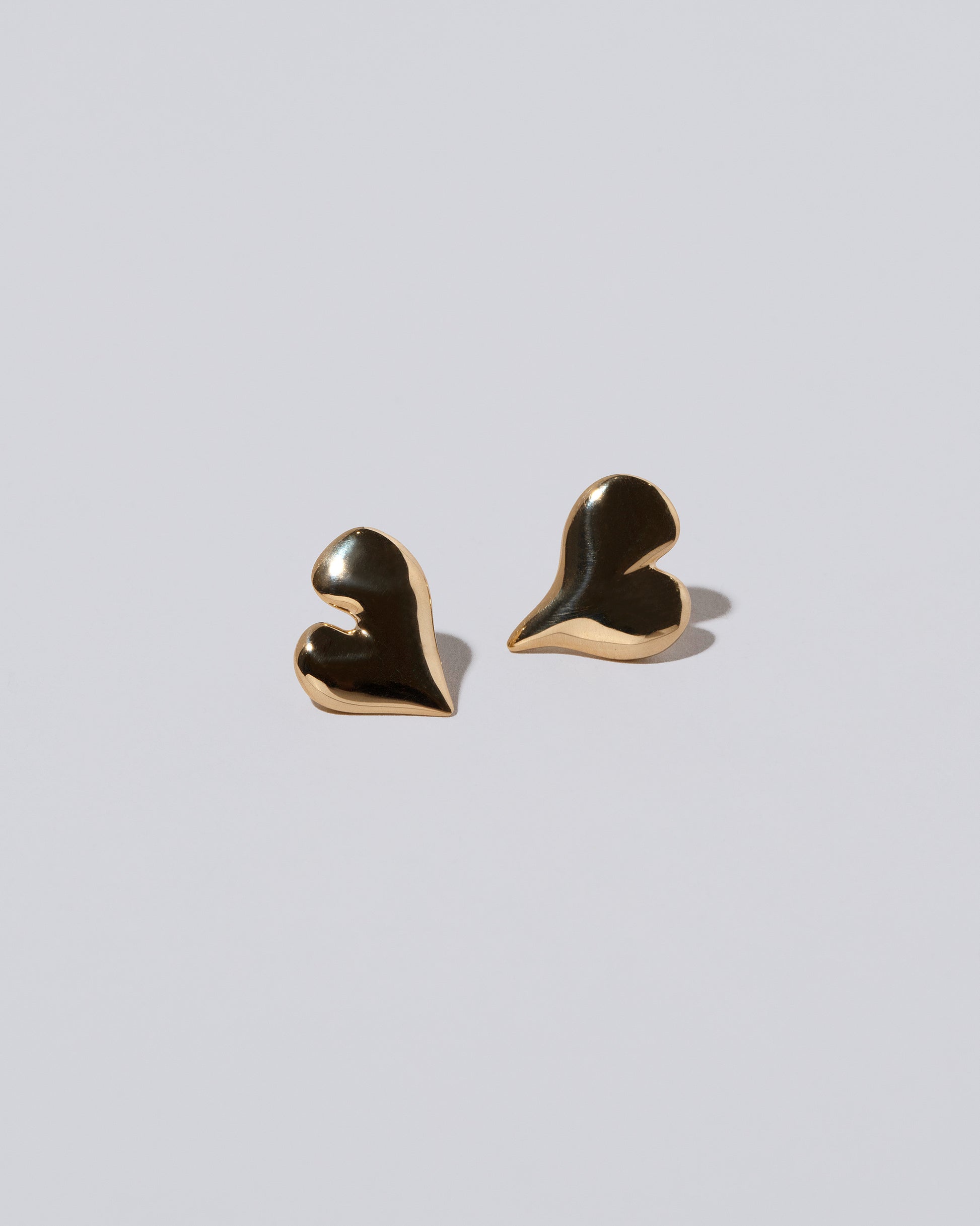 Thousand & One Night Heart Stud Earrings on light color background.