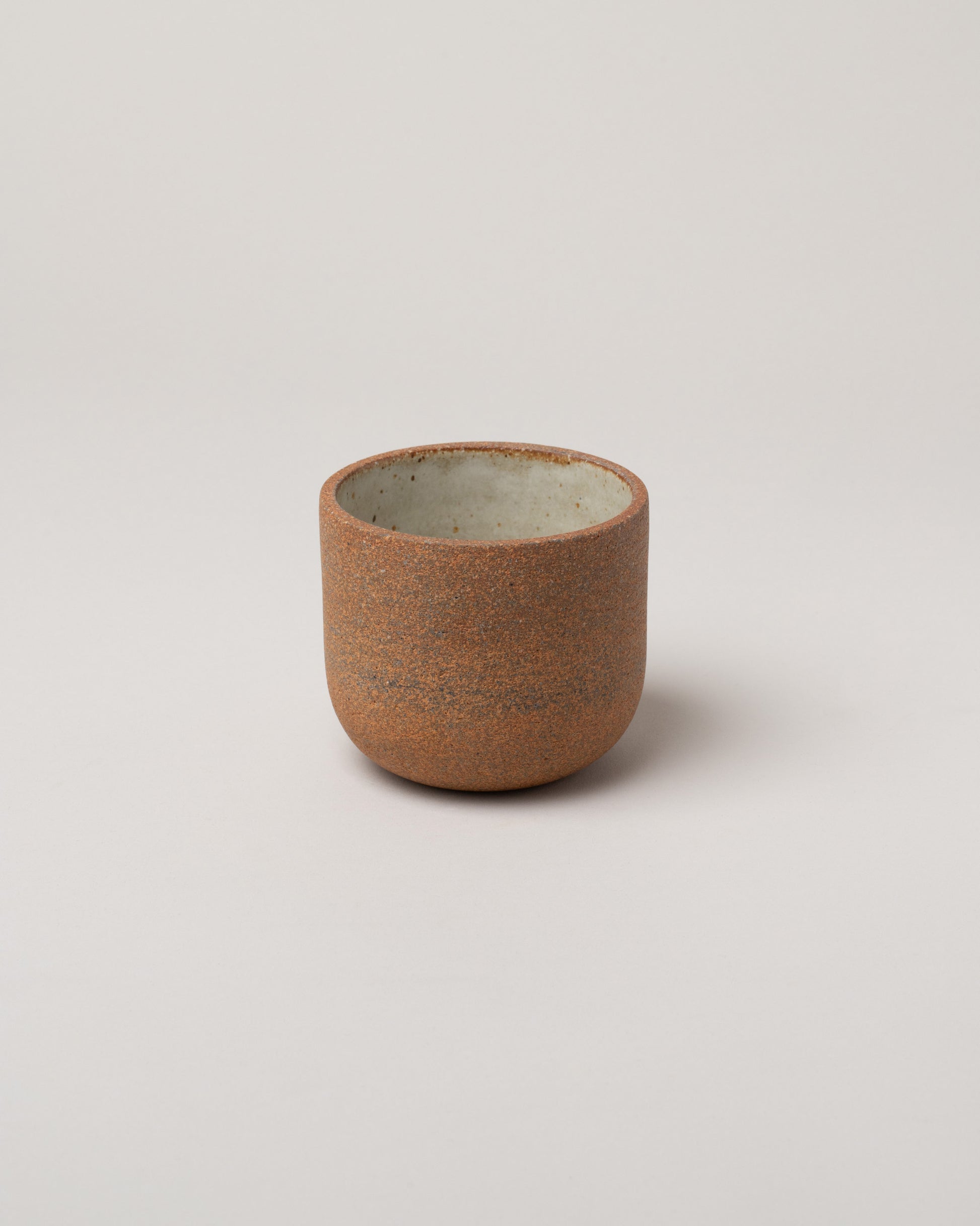 Humble Ceramics Sandstone & Raw Exterior Large Alder Tumbler on light color background.