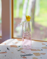 Styled image of the Ichendorf Milano Amber/Clear/Pink Travasi Bottle.