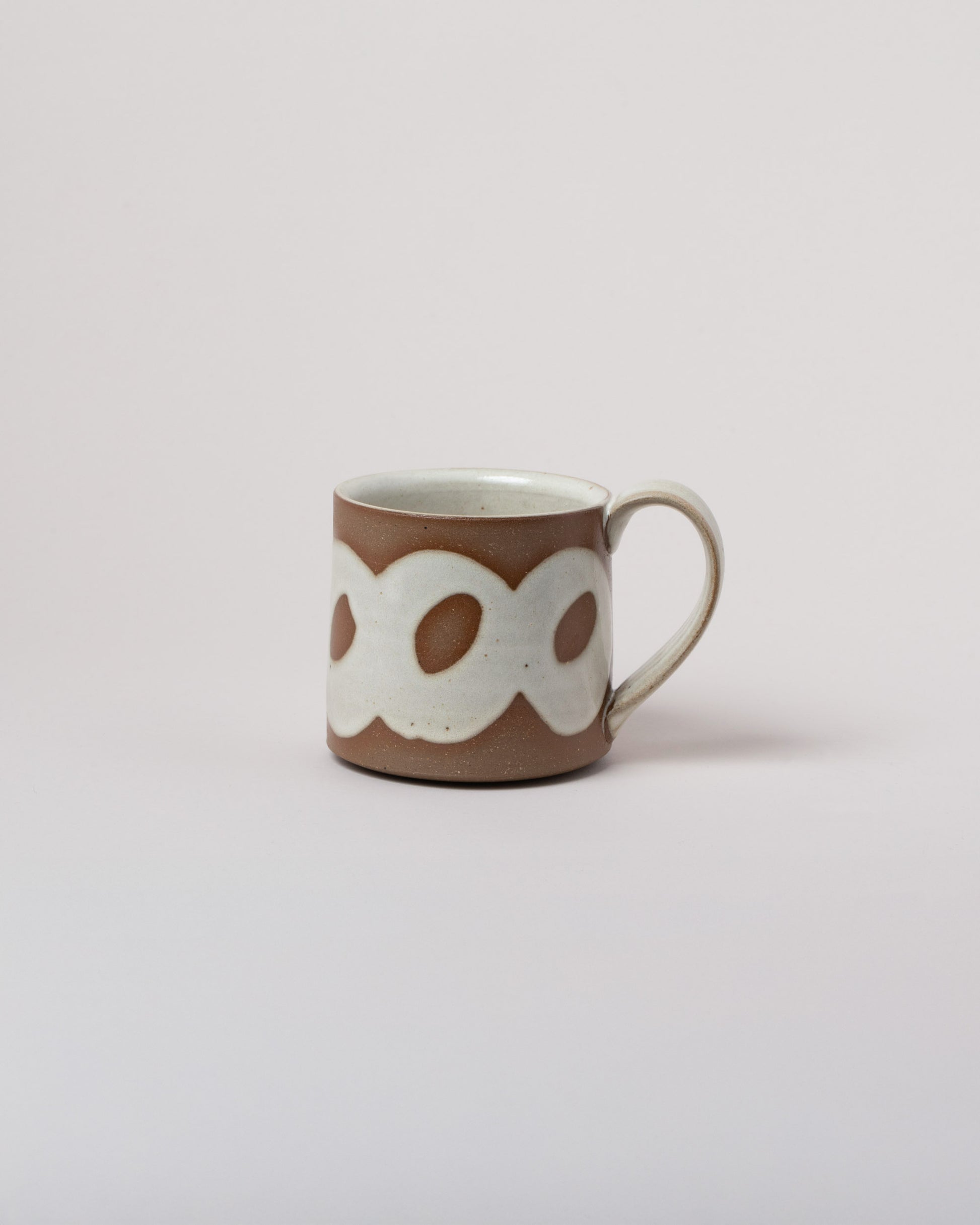 Jeremy Ayers Circle Mug on light color background.