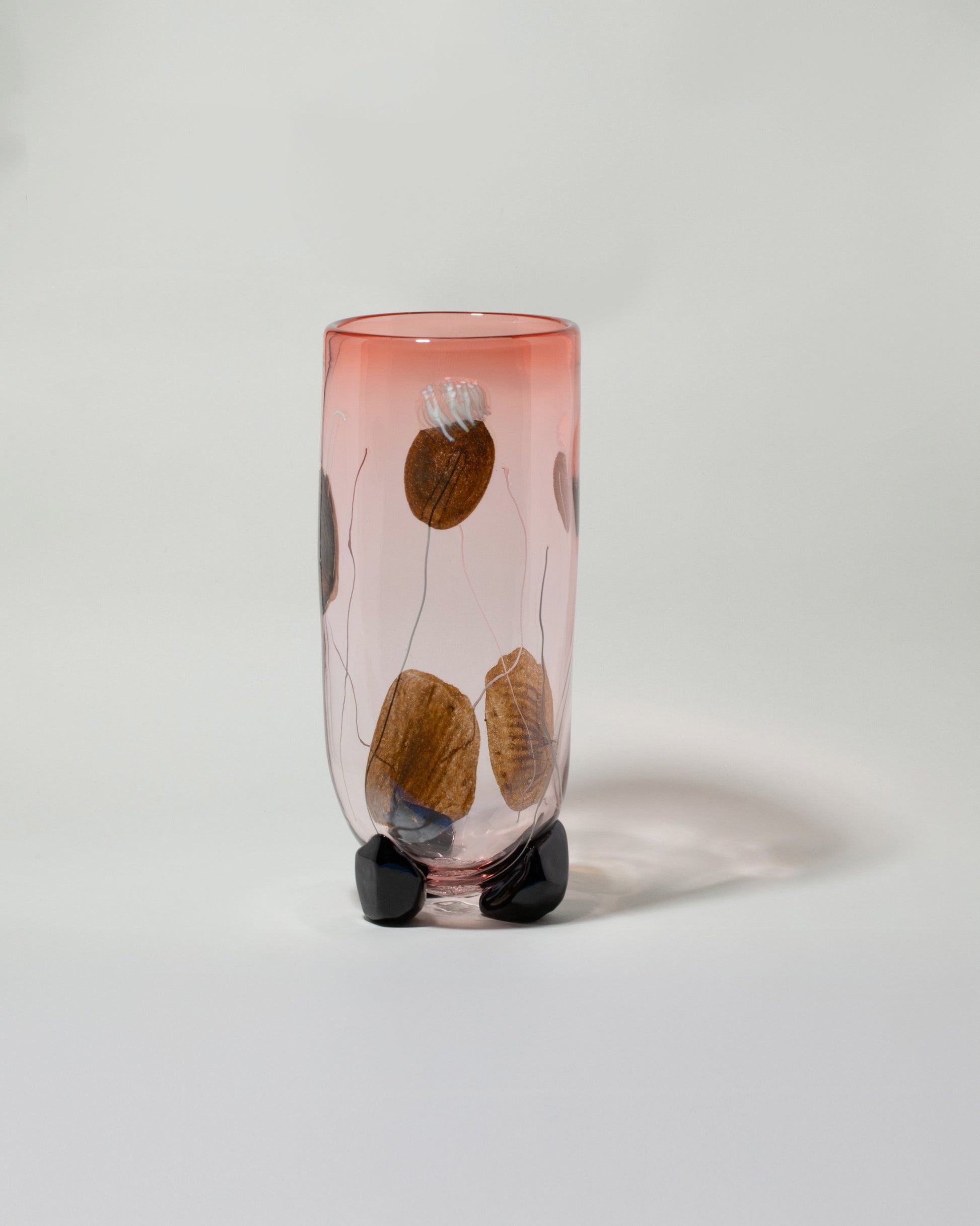 Jess Humphrey For Your Pleasure Vessel with Poppy Petals on light color background.