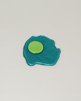 Jonny Campolo Transparent Teal For Your Pleasure Amused Boosh Egg on light color background.