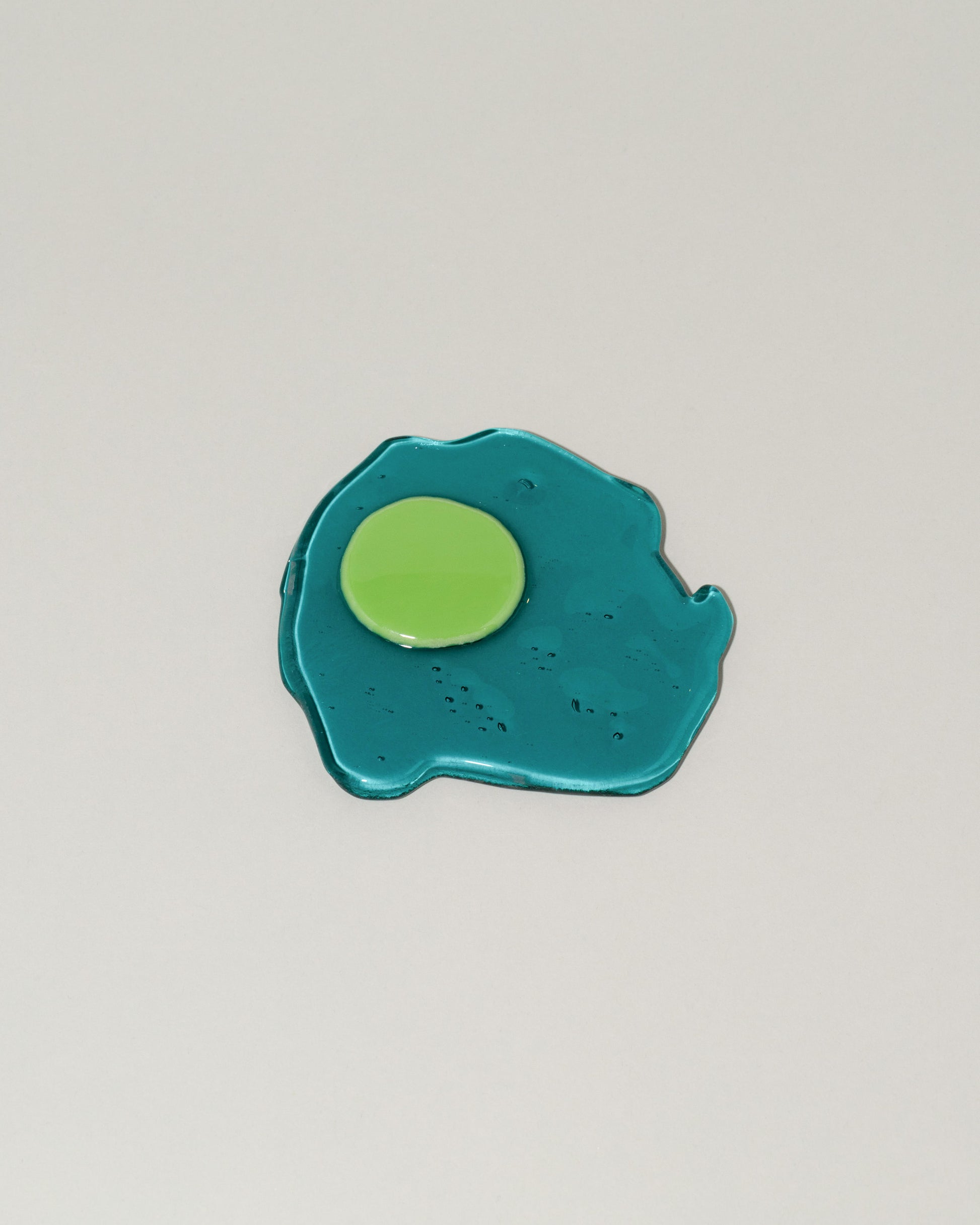 Jonny Campolo Transparent Teal For Your Pleasure Amused Boosh Egg on light color background.