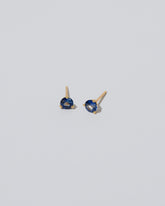 Martini Stud Earring - Blue/White Sapphire on light color background.