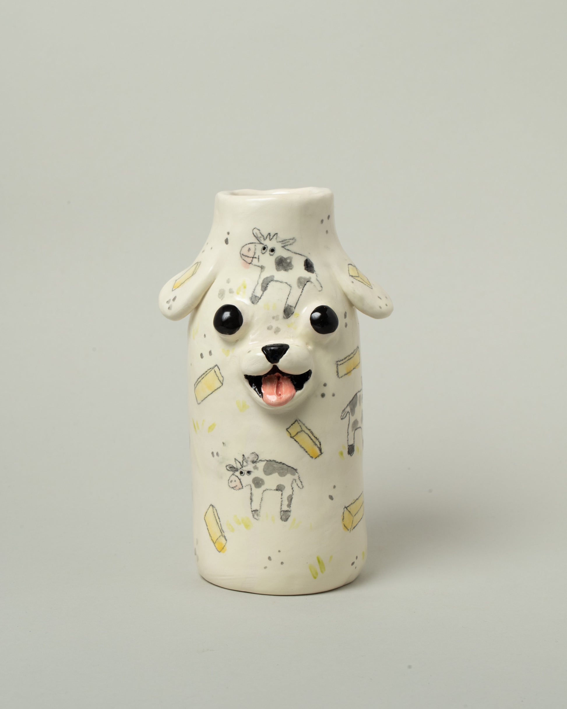 Katie Kimmel For Your Pleasure Buttermilk Puppy Vase on light color background.