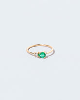 Emerald & Diamond Teardrop Ring on light color background.