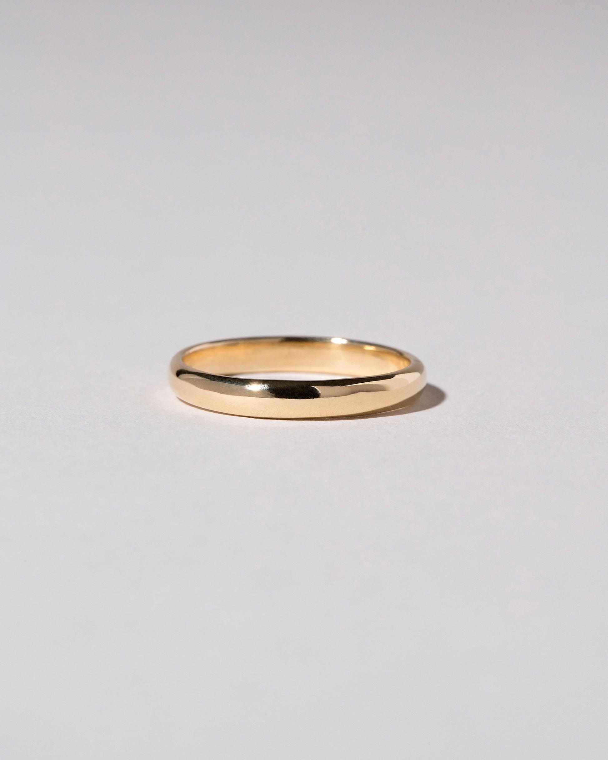 Gold 2.5mm Half Round Wire Band on light color background.