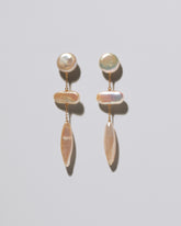 Heron Pearl Earrings on light color background.