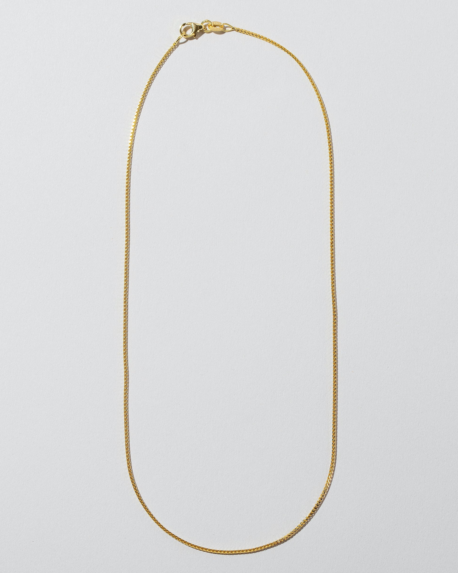 Gold 18" 1.5mm Ritual Chain Necklace on light color background.