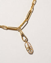 Closeup details of the Grand Swivel Fob with Chain and charm on light color background.