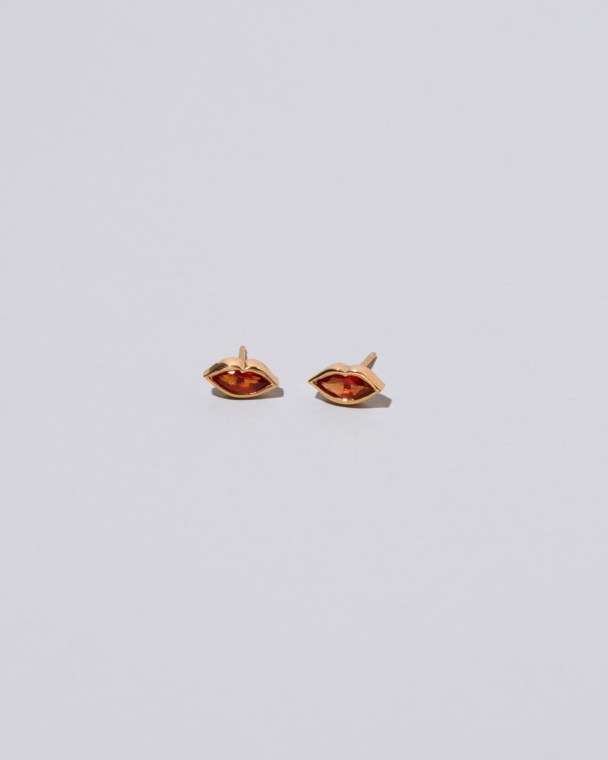 Red Big Kiss Stud Earrings on light color background.