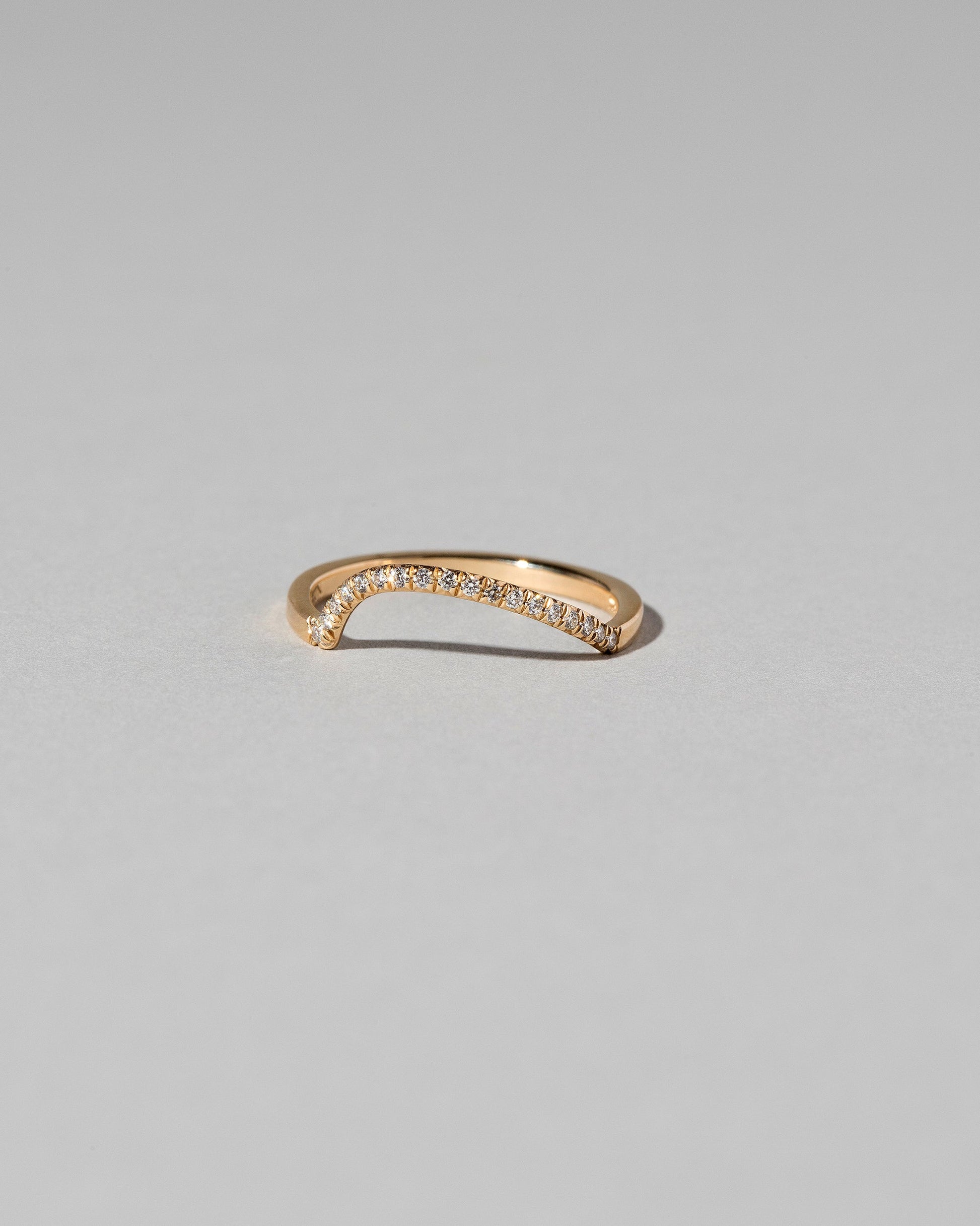 Gold Pavé White Diamond Left Slump Band on light color background.