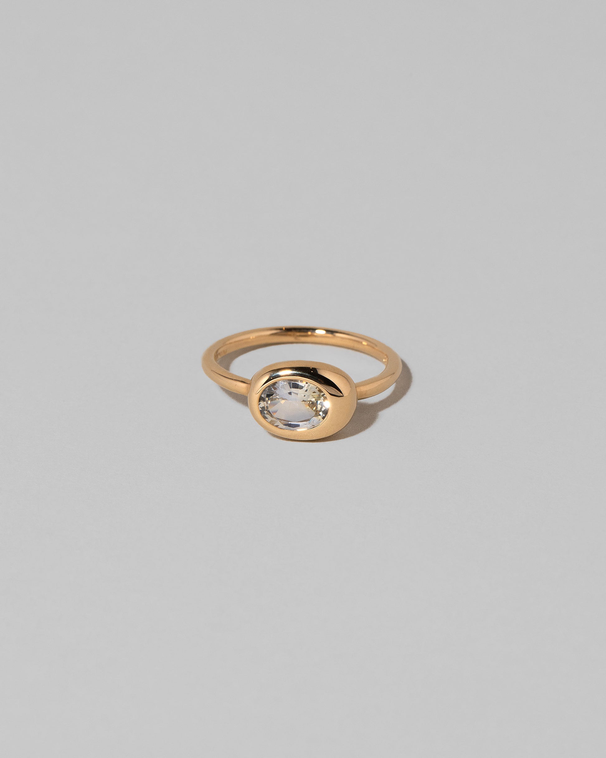 Oval Sapphire Equalize Ring on light color background.