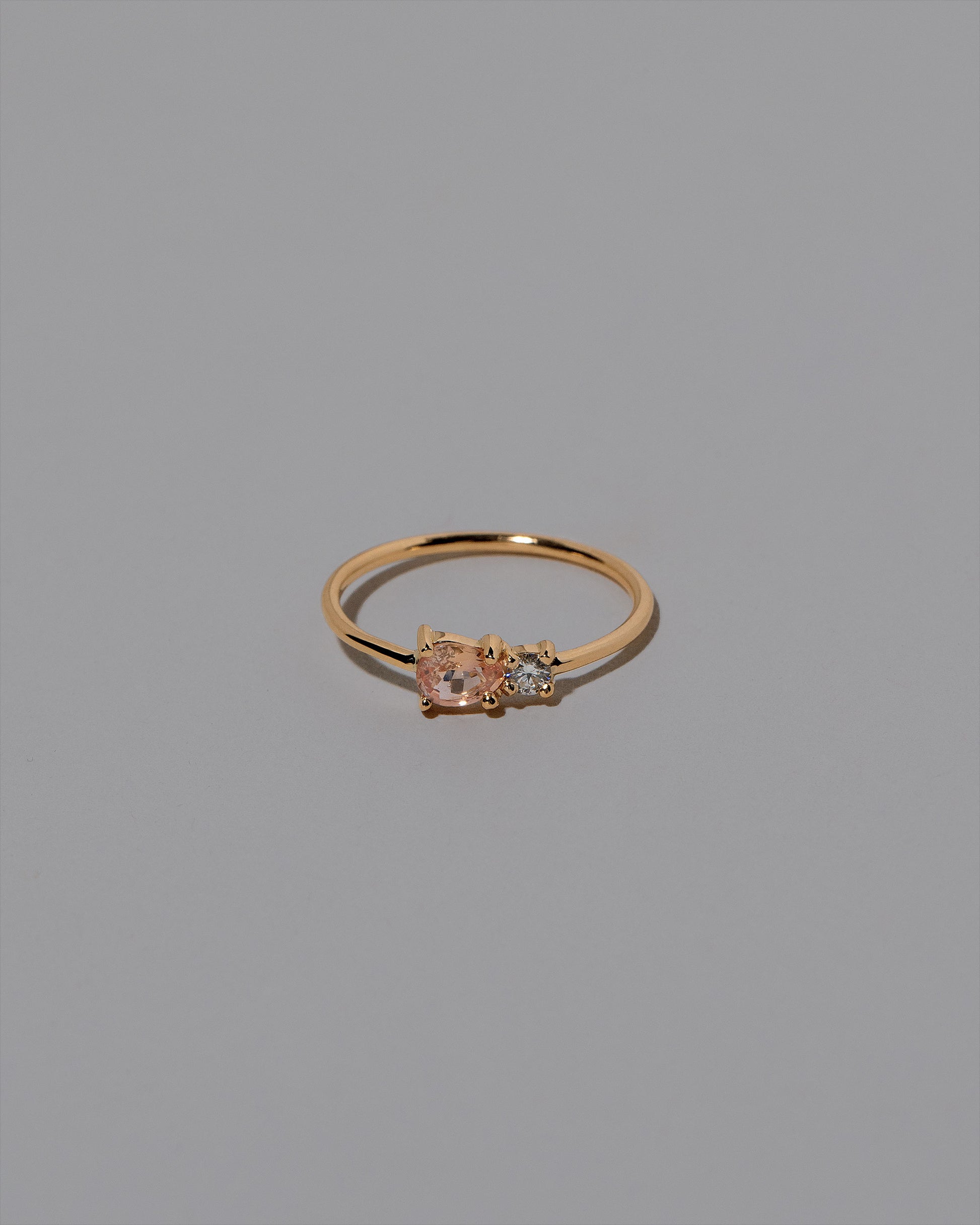 Peach Sapphire Teardrop Ring on light color background.