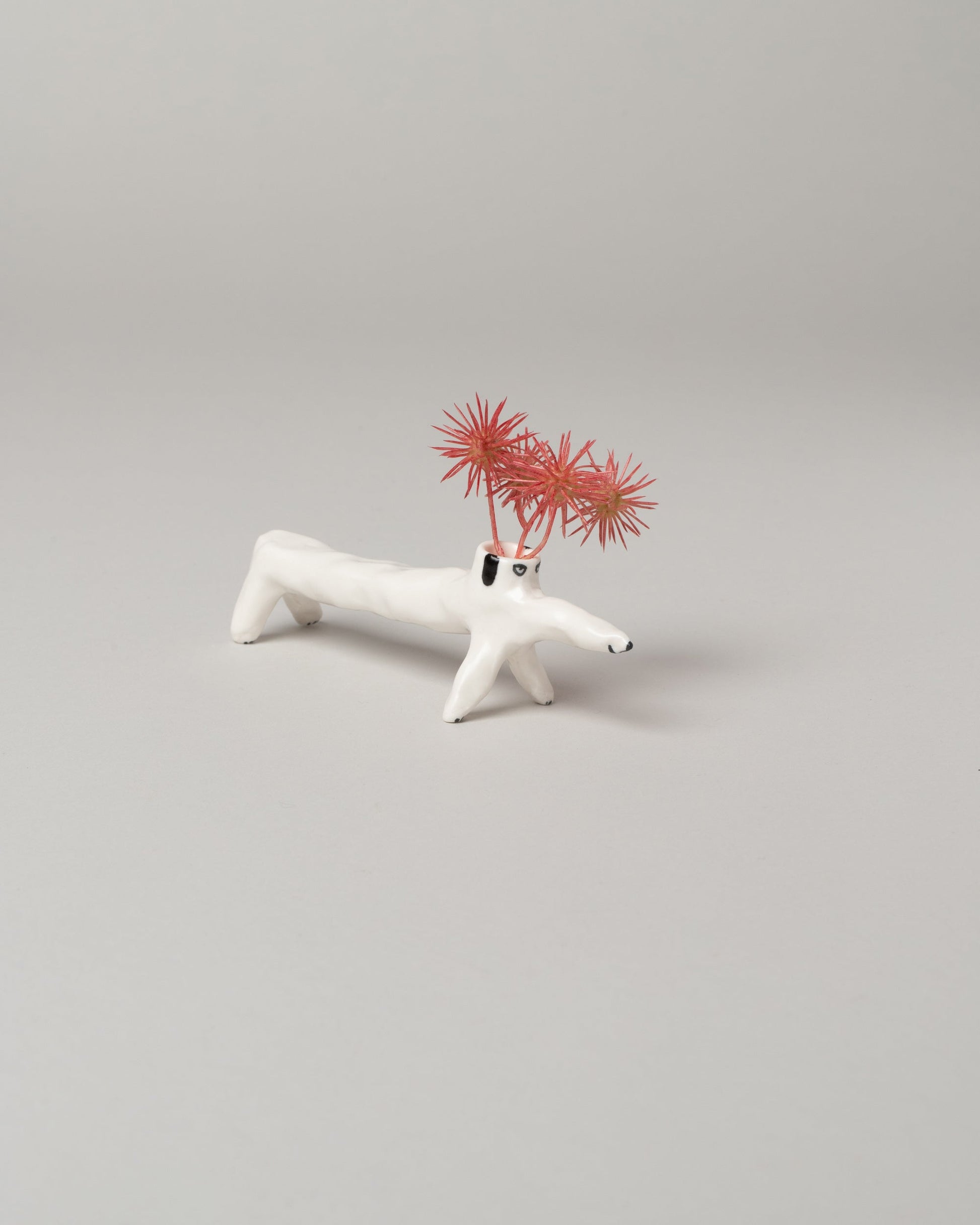 Detail view of the Eleonor Boström Long Dog Dog Vase on light color background.