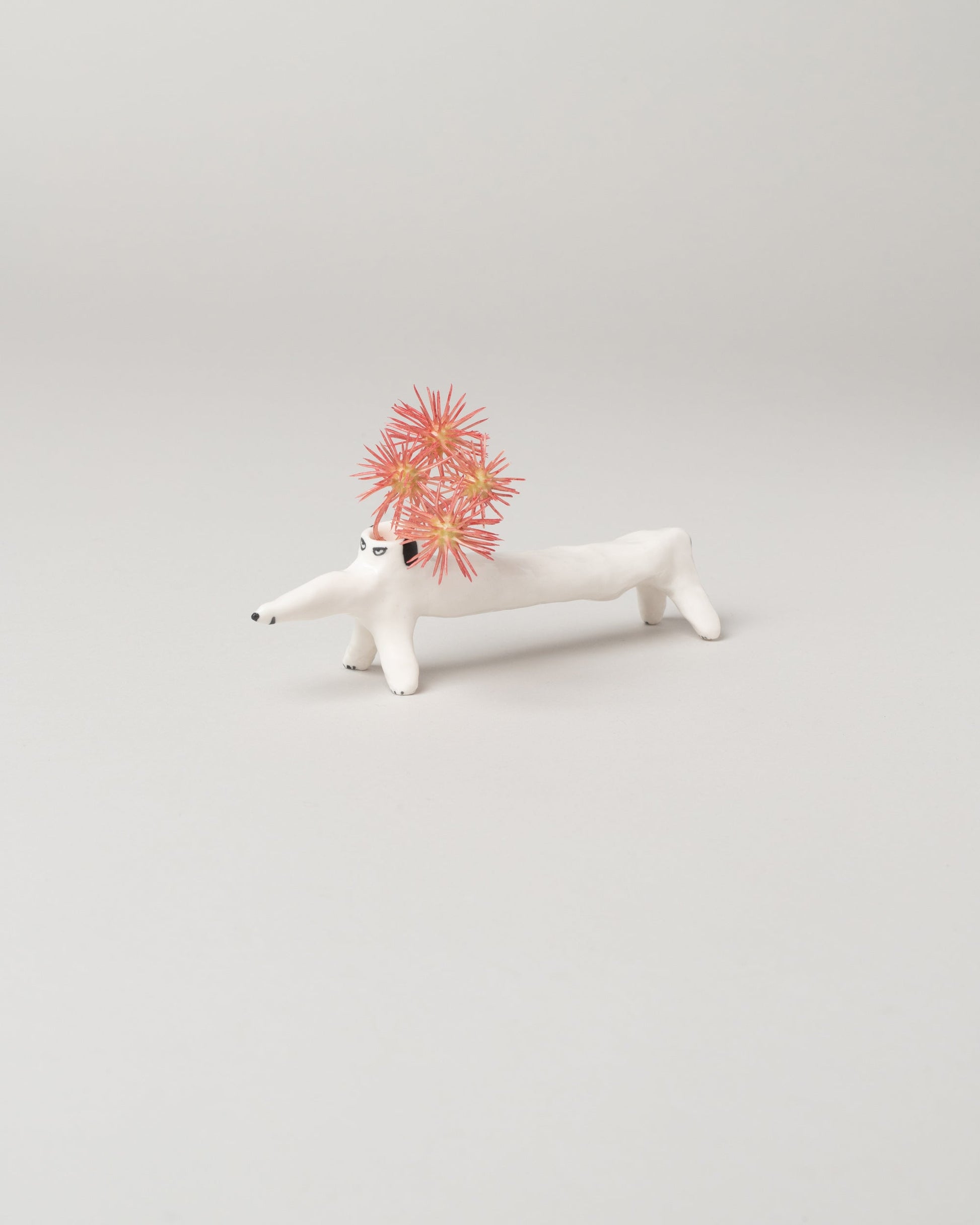 Detail view of the Eleonor Boström Long Dog Dog Vase on light color background.