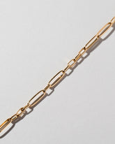 Closeup details of the Long Loop Chain Bracelet on light color background.