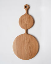 Lucas Castex No. 06 Hand-Carved Oak Wood Serving Board on light color background.