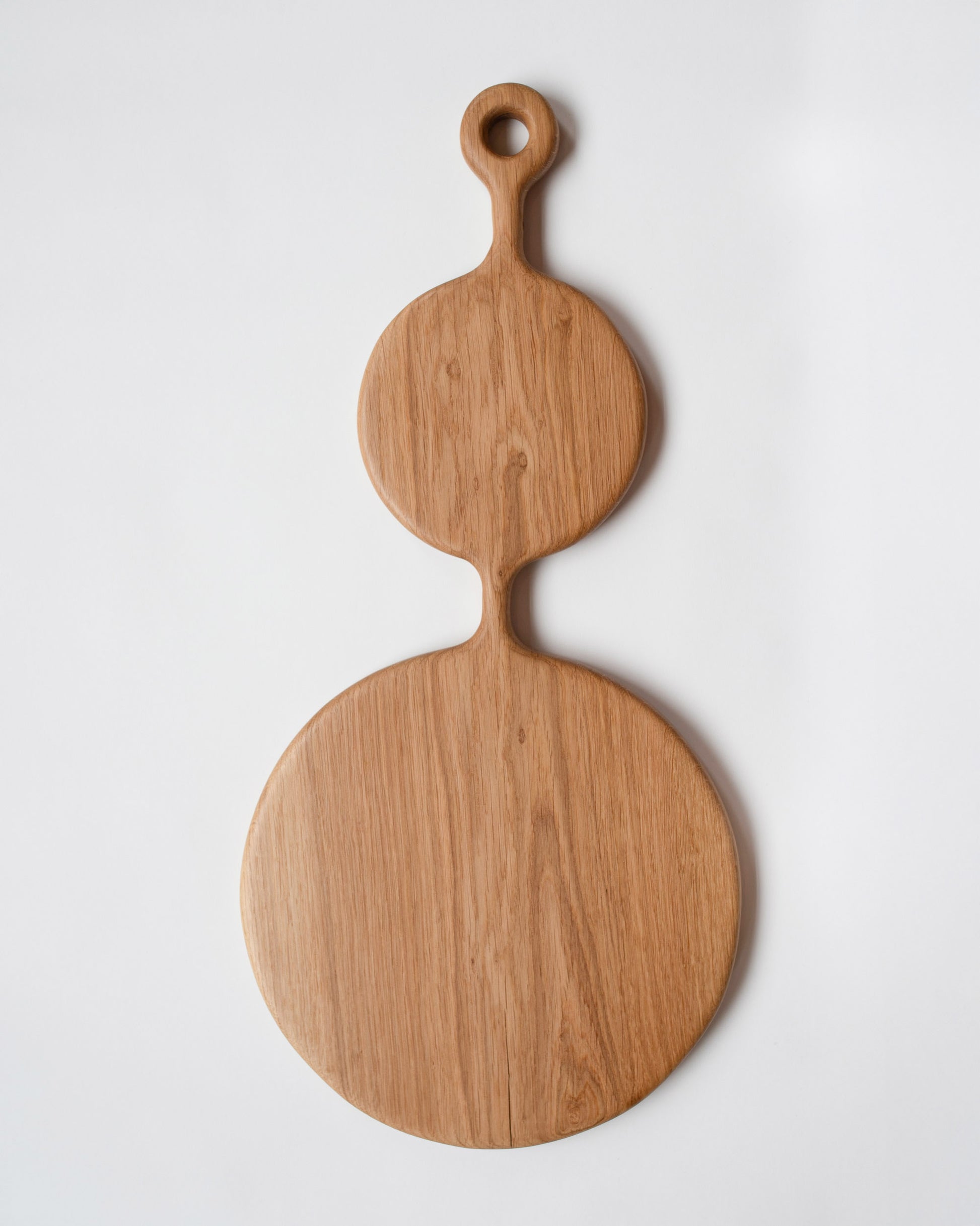 Lucas Castex No. 06 Hand-Carved Oak Wood Serving Board on light color background.