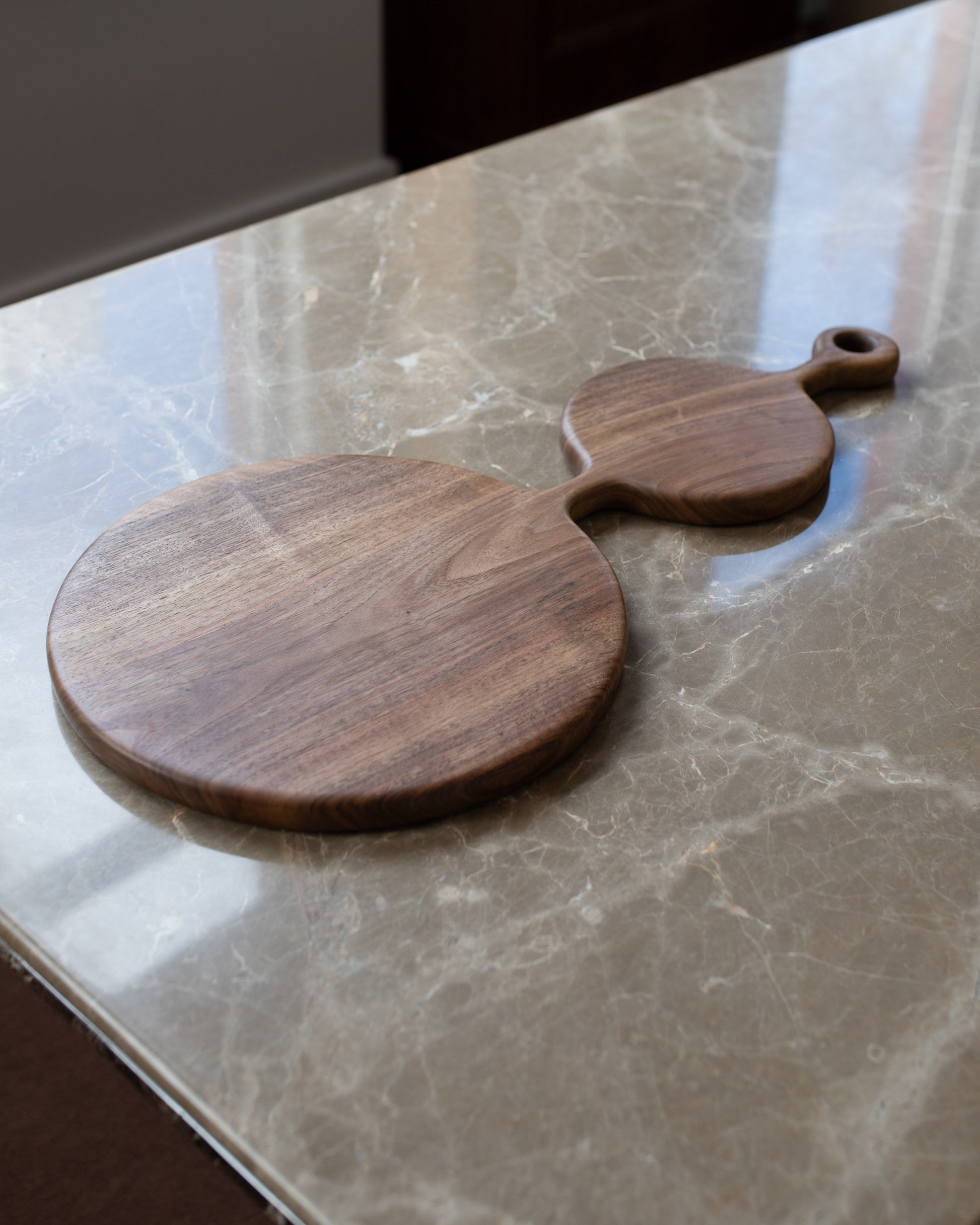 Styled image featuring the Lucas Castex No. 06 Hand-Carved Walnut Wood Serving Board.