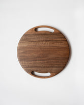 Lucas Castex No. 08 Hand-Carved Walnut Wood Serving Board on light color background.