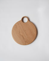 Lucas Castex No. 10 Hand-Carved Oak Wood Serving Board on light color background.