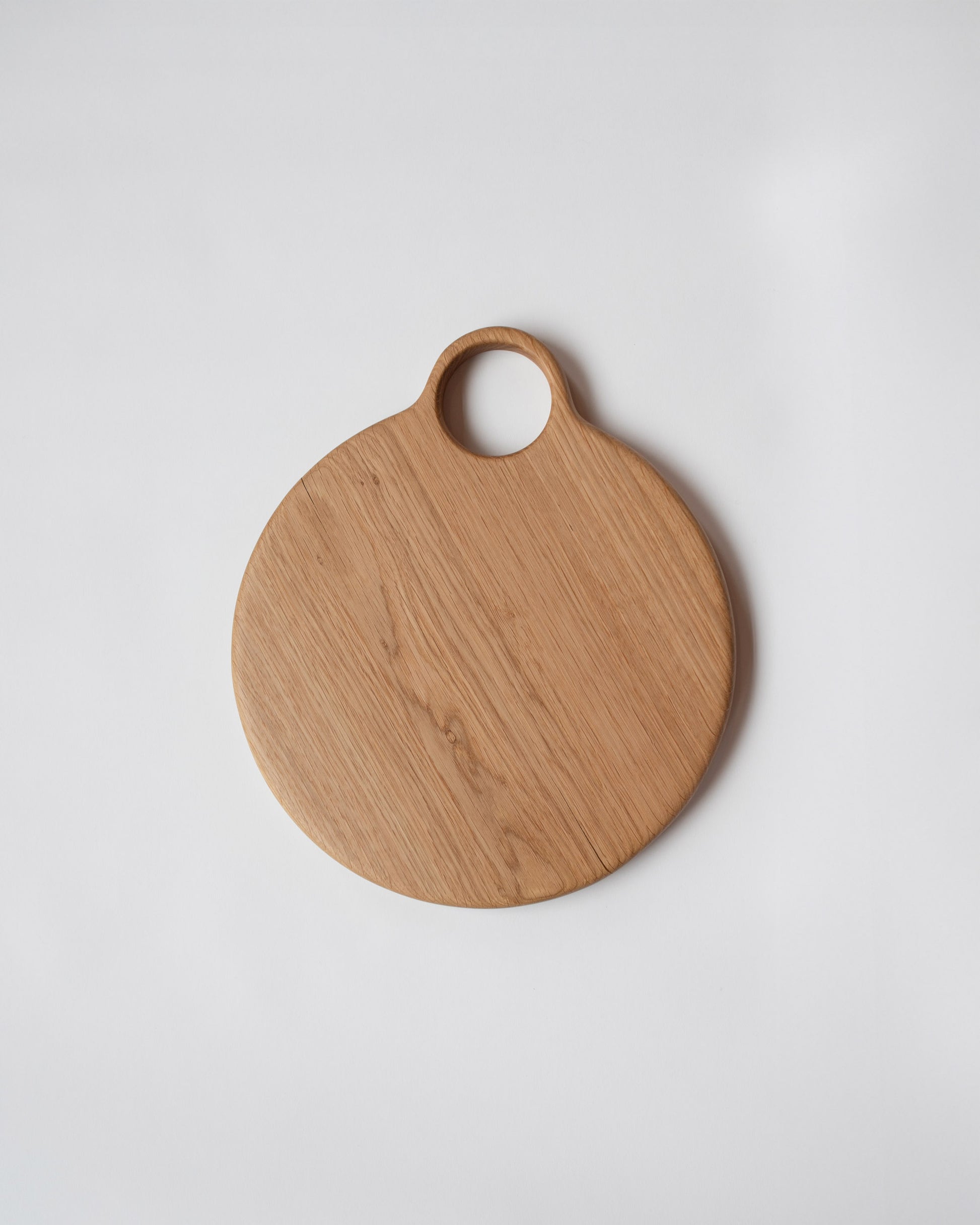 Lucas Castex No. 10 Hand-Carved Oak Wood Serving Board on light color background.