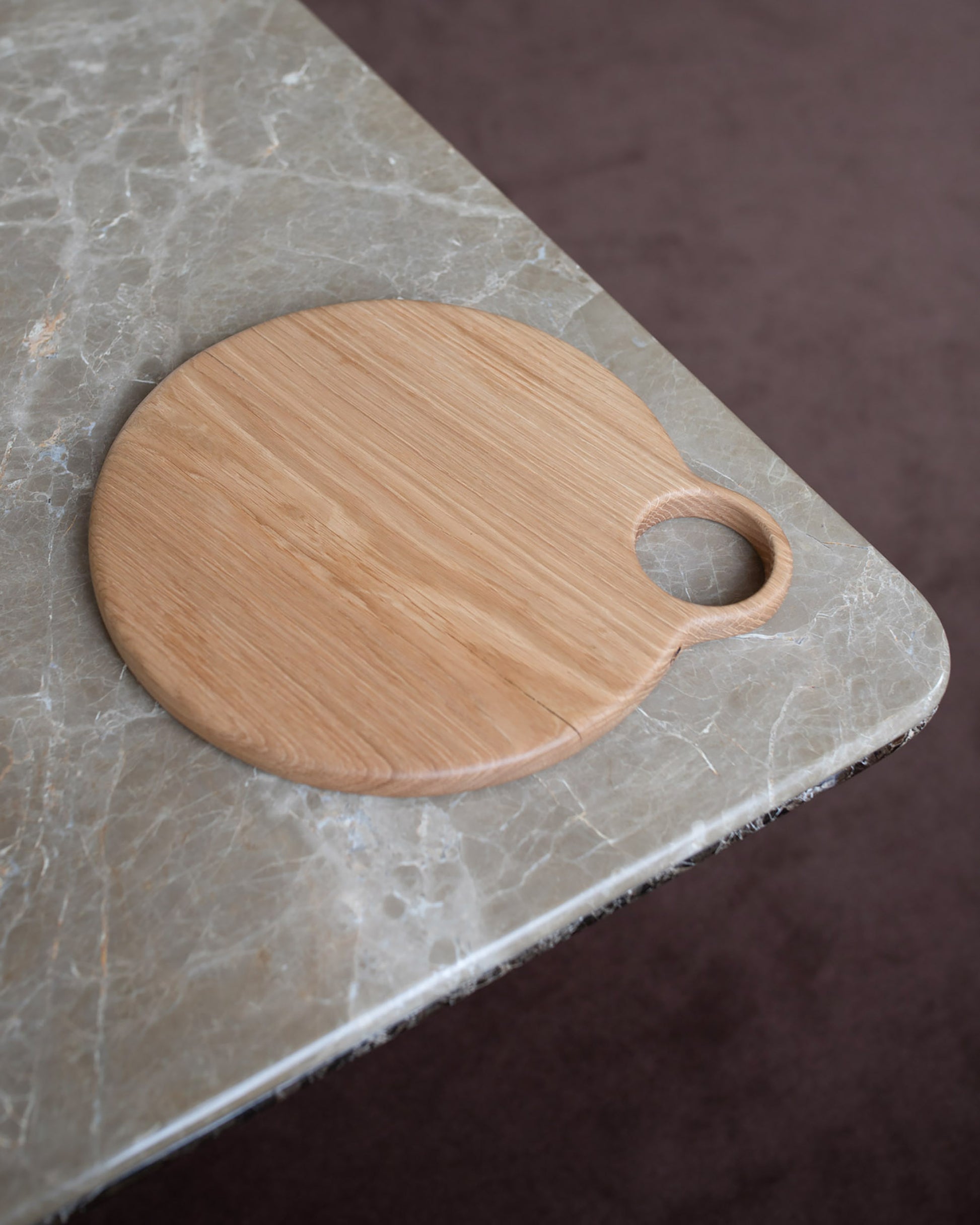 Styled image featuring the Lucas Castex No. 10 Hand-Carved Oak Wood Serving Board.