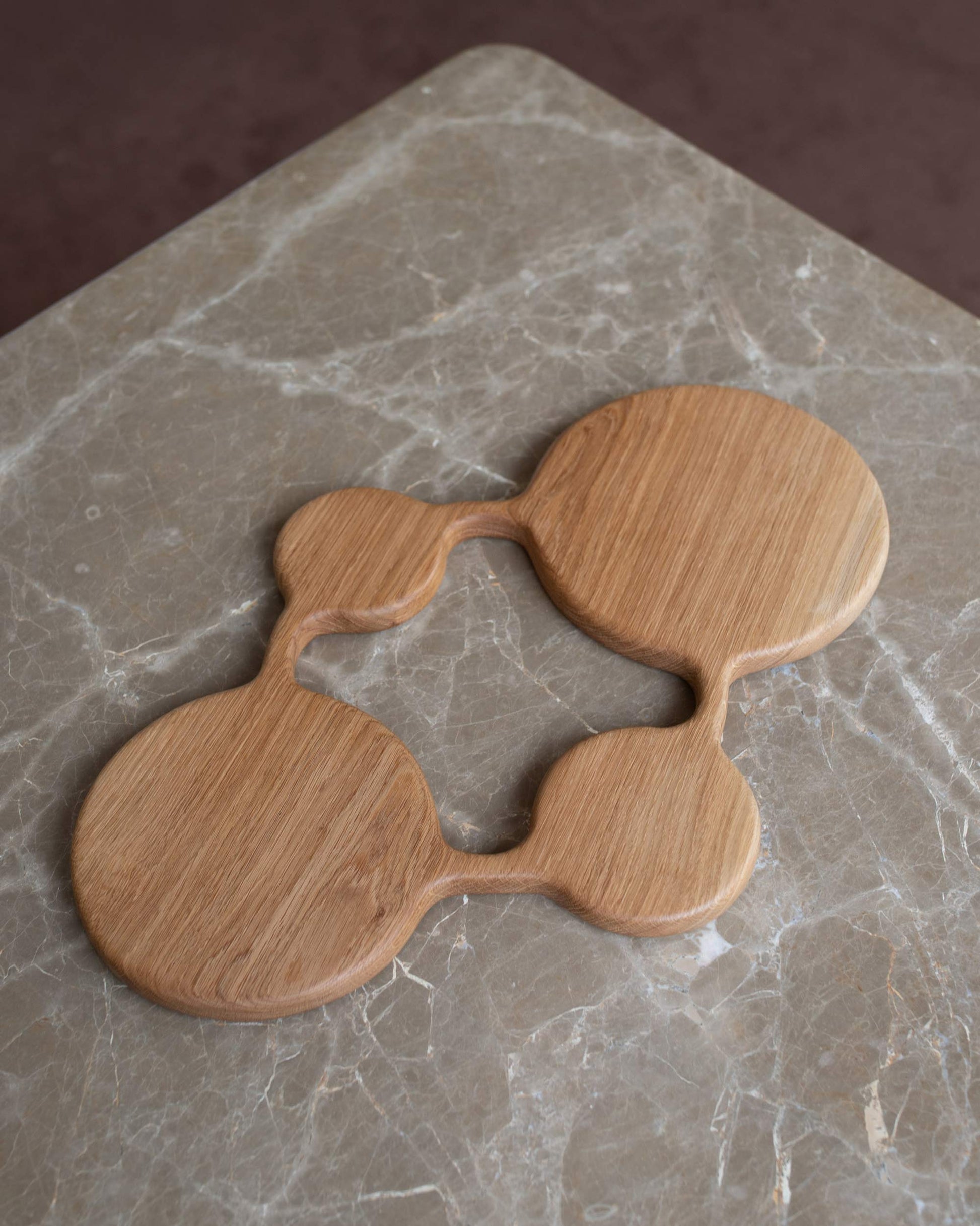 Styled image featuring the Lucas Castex No. 13 Hand-Carved Oak Wood Serving Board.