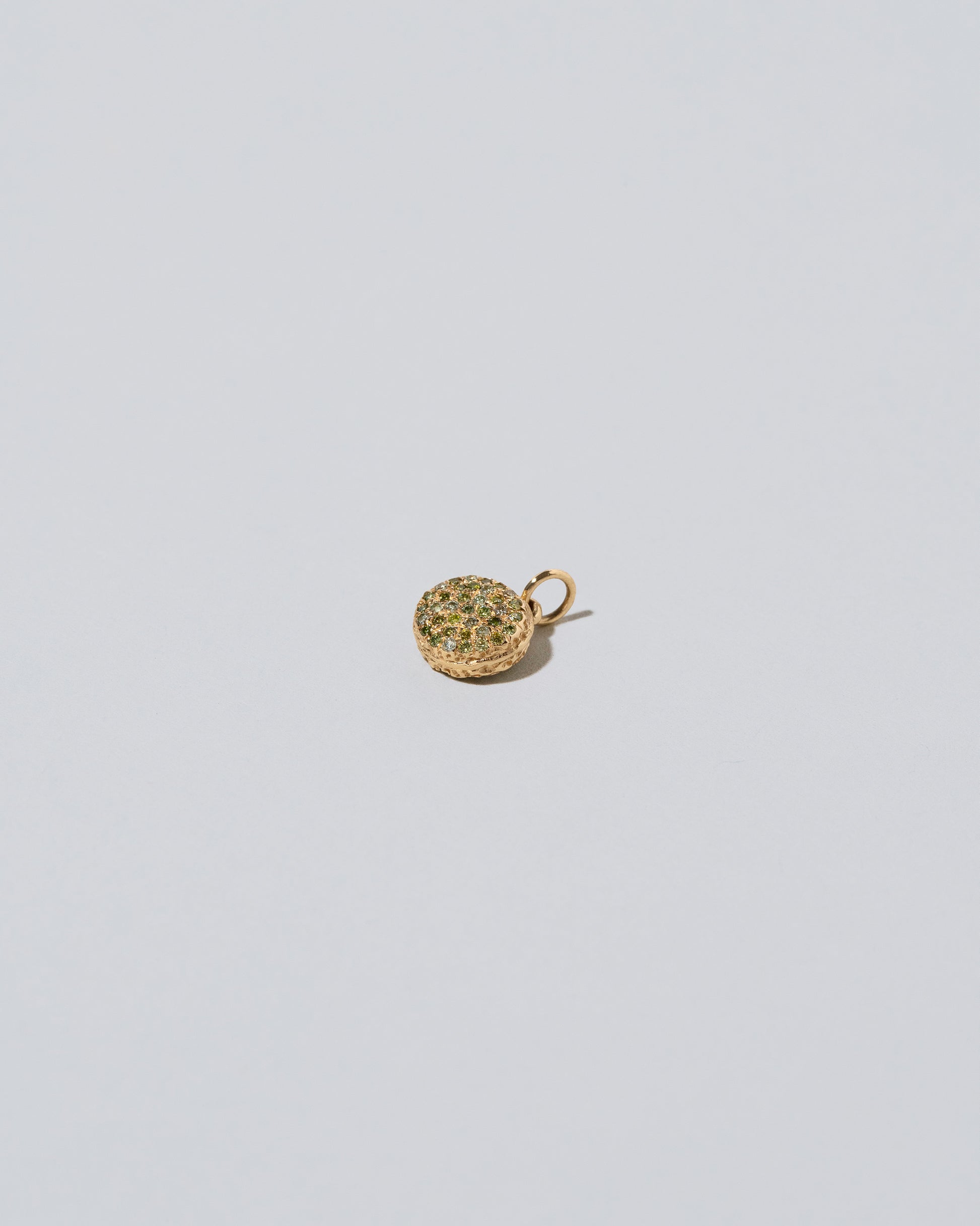 Mini Macaron Charm - Diamond Pavé Pistachio on light color background.