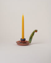 Maggie Boyd Candle Holder With Long Handle on light color background.