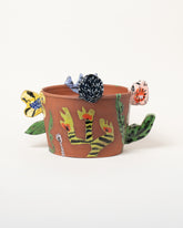 Maggie Boyd Flower Planter on light color background.