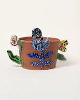 View from the back of the Maggie Boyd Flower Planter on light color background.