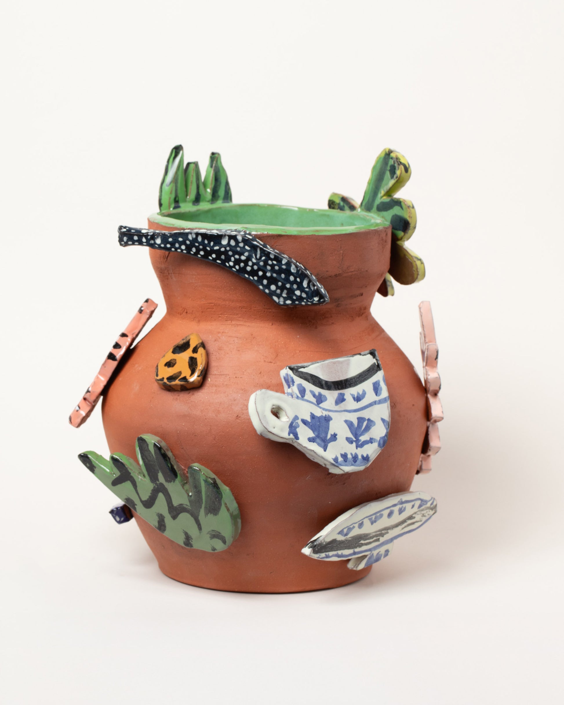 View from the back of the Maggie Boyd Large Cut Out Vase on light color background.