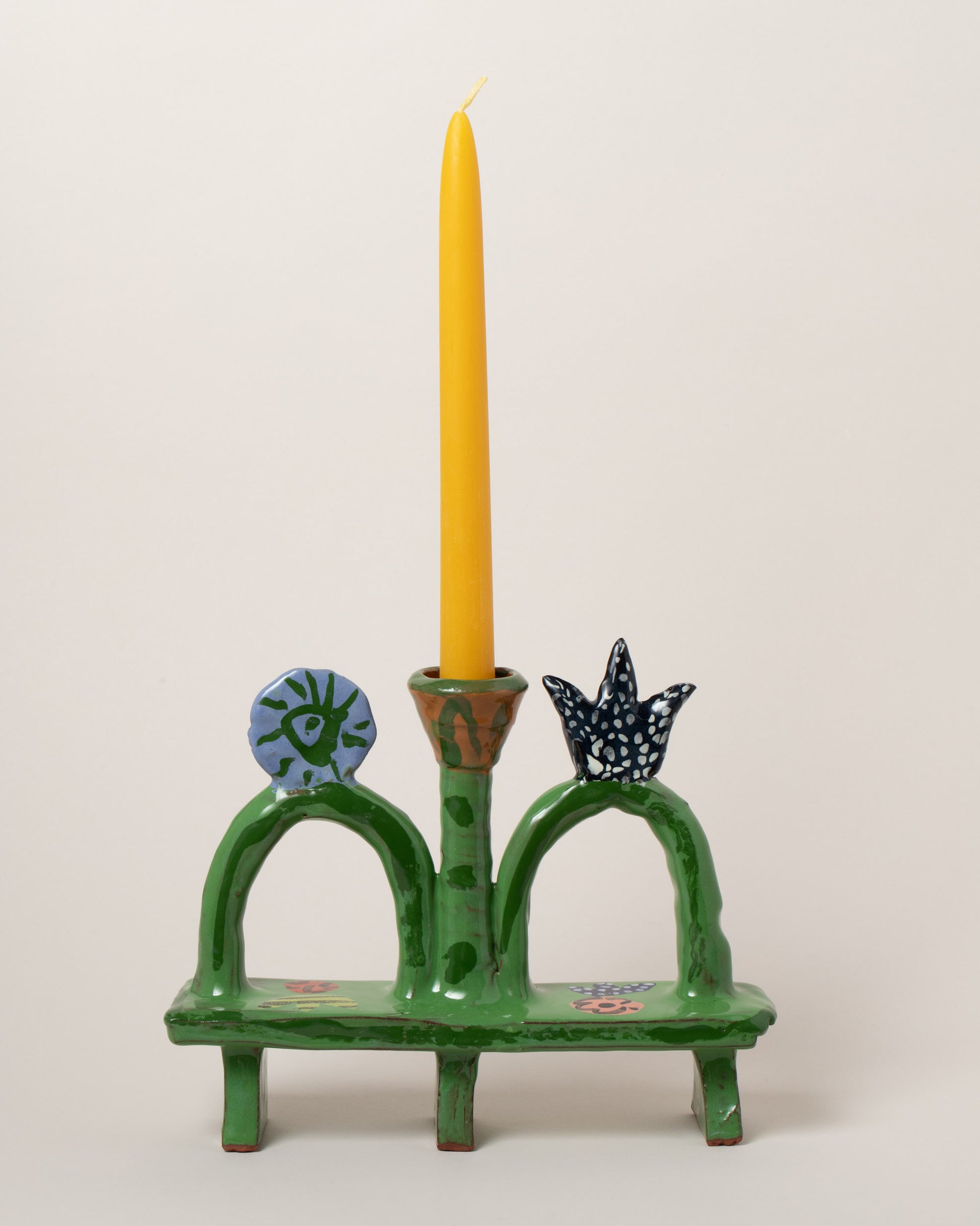 Detail view of the Maggie Boyd Green Park Bench Candle Holder on light color background.