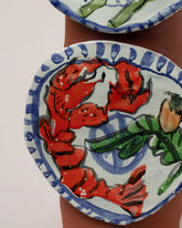 Closeup details of the Maggie Boyd Trompe LOL Plate Vase on light color background.