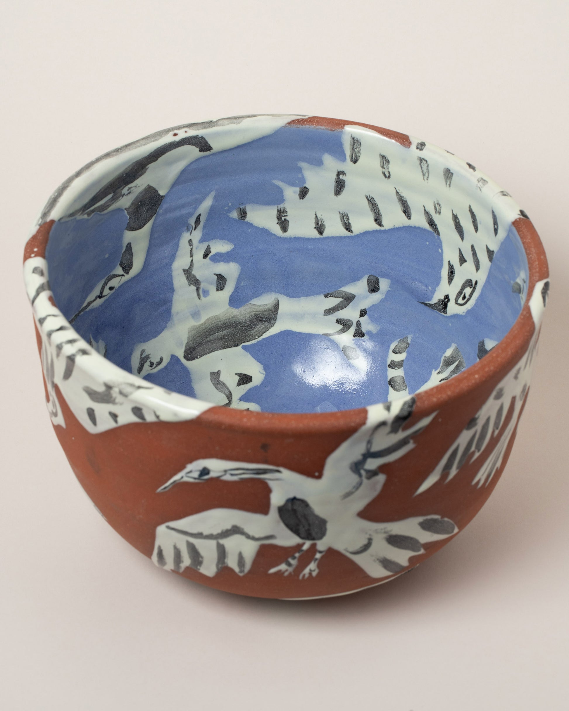 Closeup details of the Maggie Boyd Birds Salad Bowl on light color background.