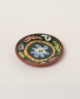 Maggie Boyd Green Bird & Peanut Side Plate on light color background.