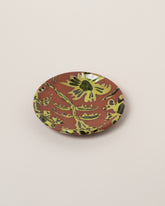Maggie Boyd Chartreuse One Clay Flower Side Plate on light color background.