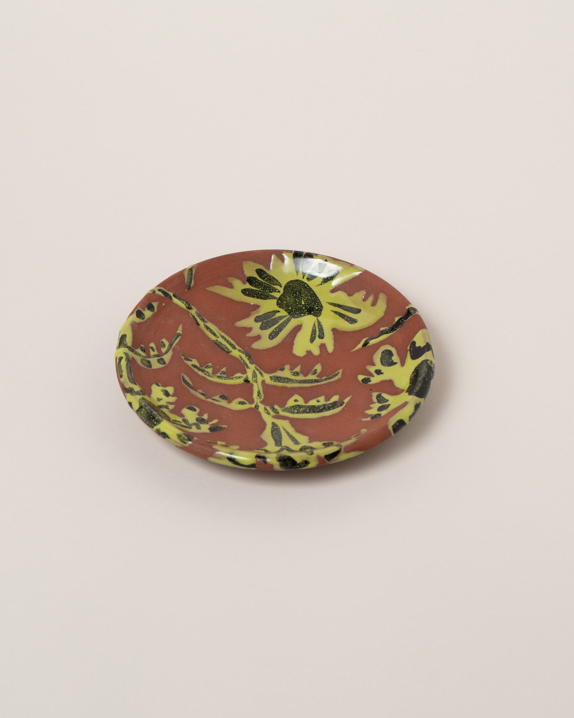 Maggie Boyd Chartreuse One Clay Flower Side Plate on light color background.