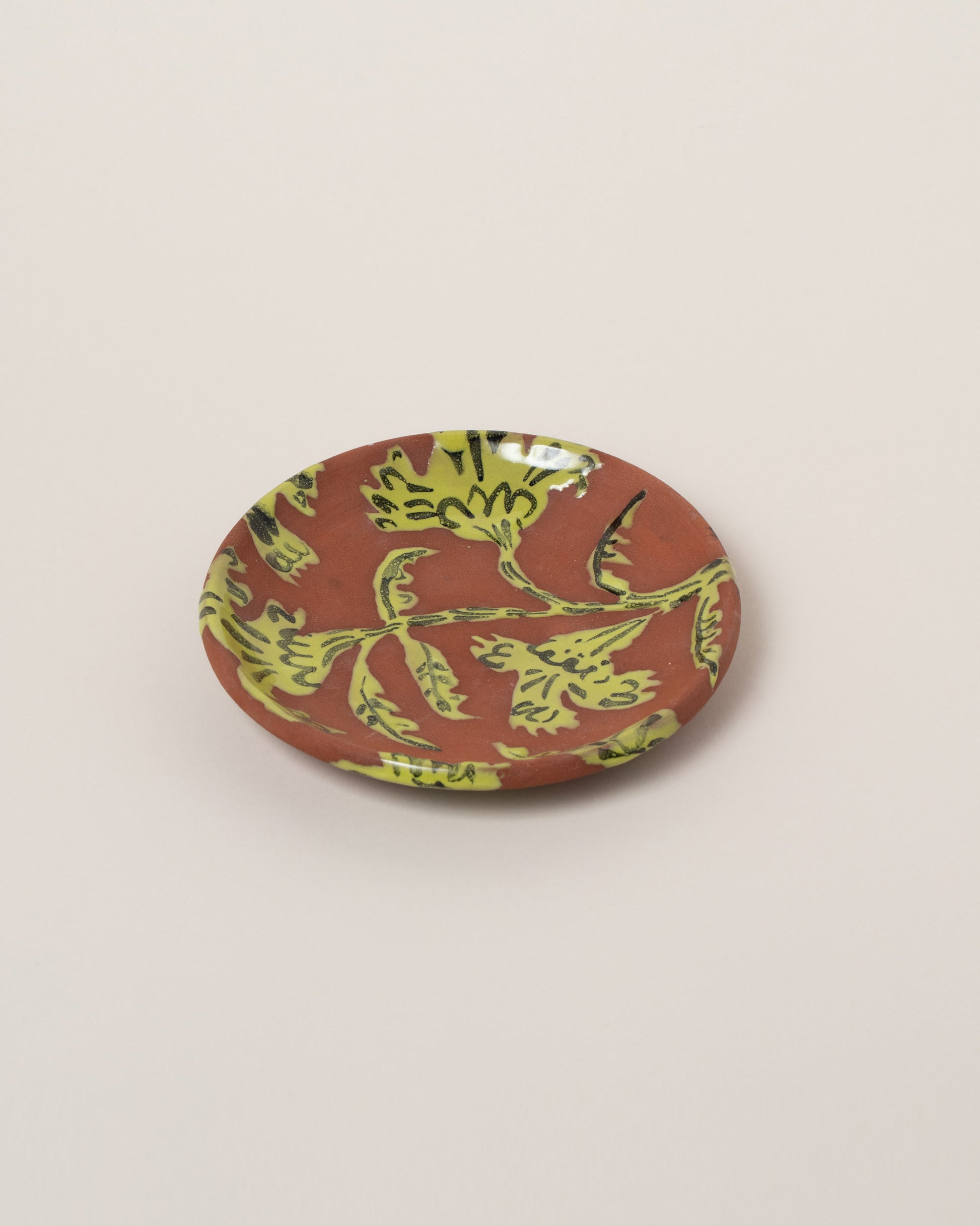 Maggie Boyd Chartreuse Two Clay Flower Side Plate on light color background.