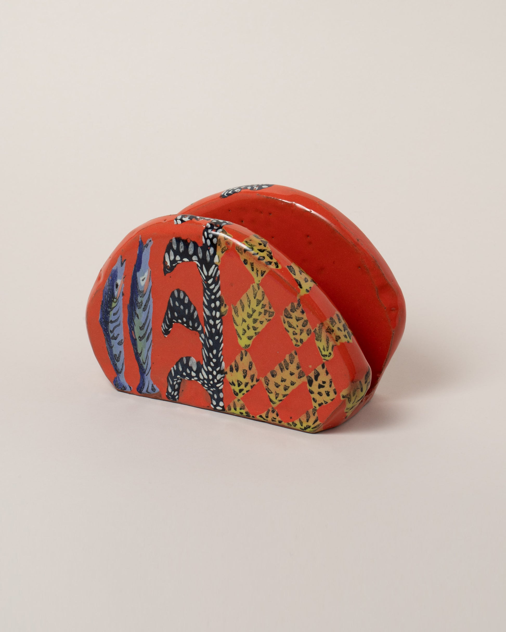 Maggie Boyd napkin holder on light color background.