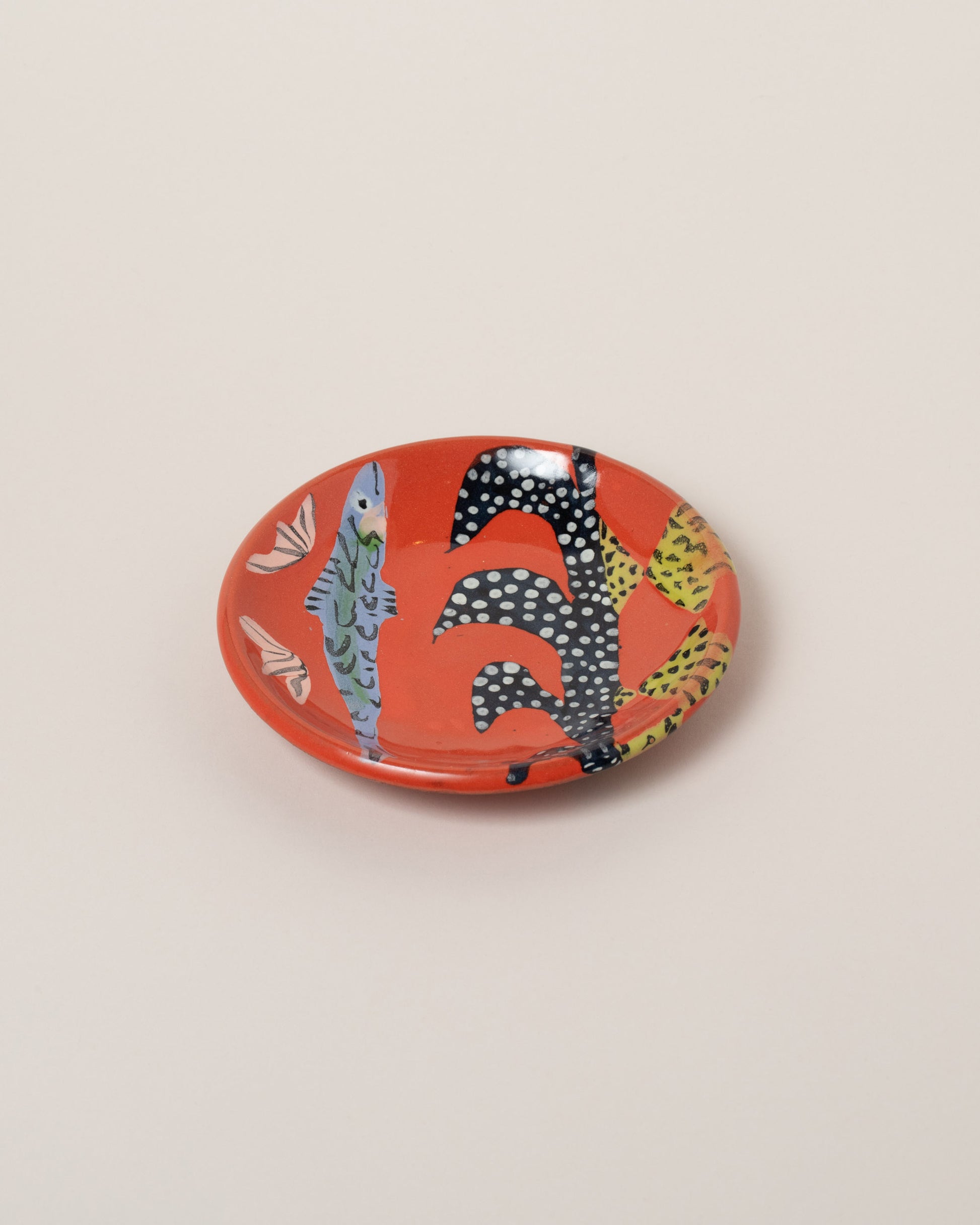 Maggie Boyd Two Red Hot Small Side Plate on light color background.