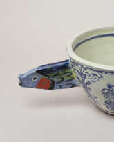 Closeup details of the Maggie Boyd Sardine Swimming Through Delftware Bowl on light color background.