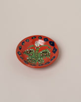 Maggie Boyd Small Red Moth To The Moon Dish on light color background.
